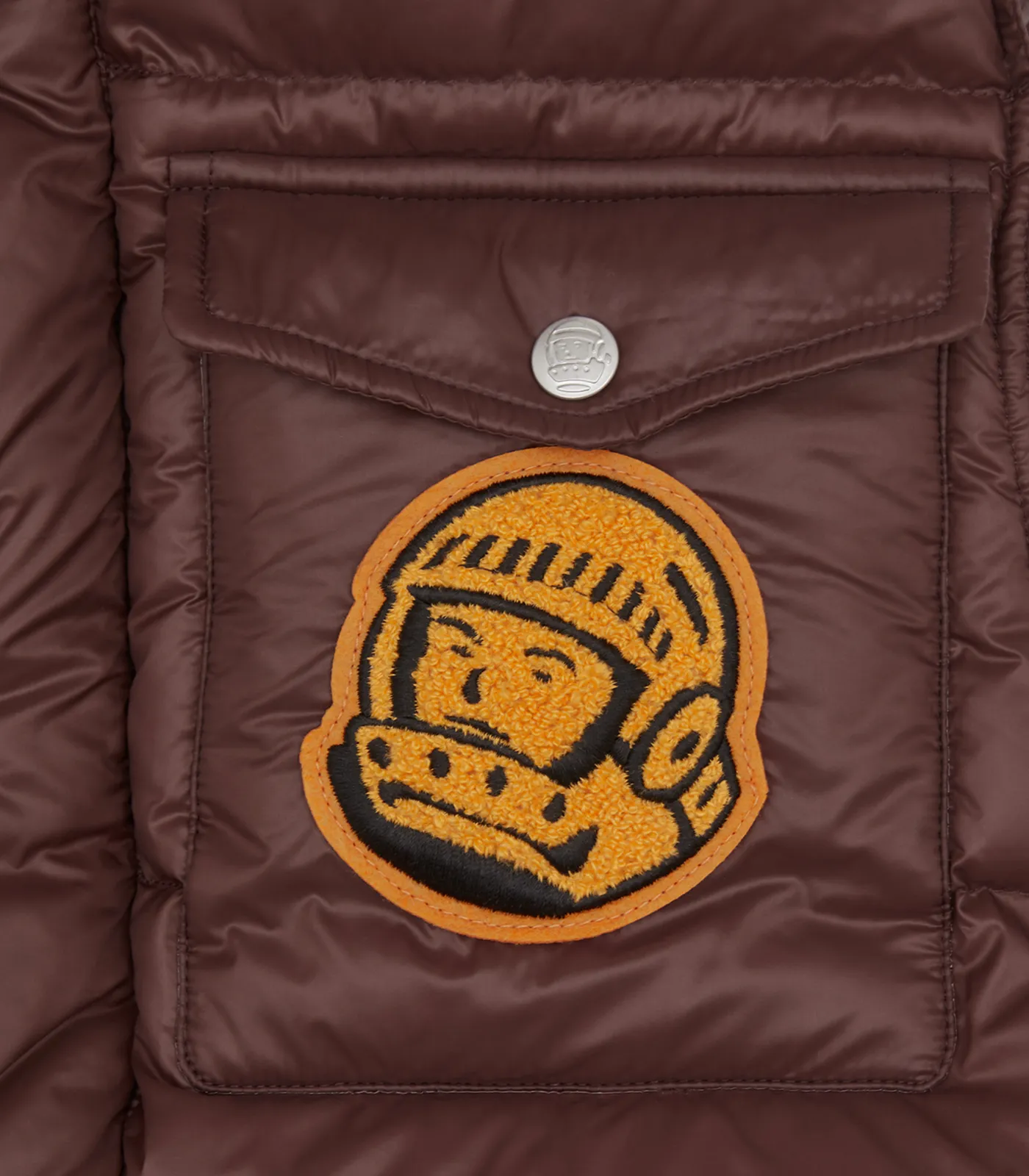 Brown down filled gilet with patches.