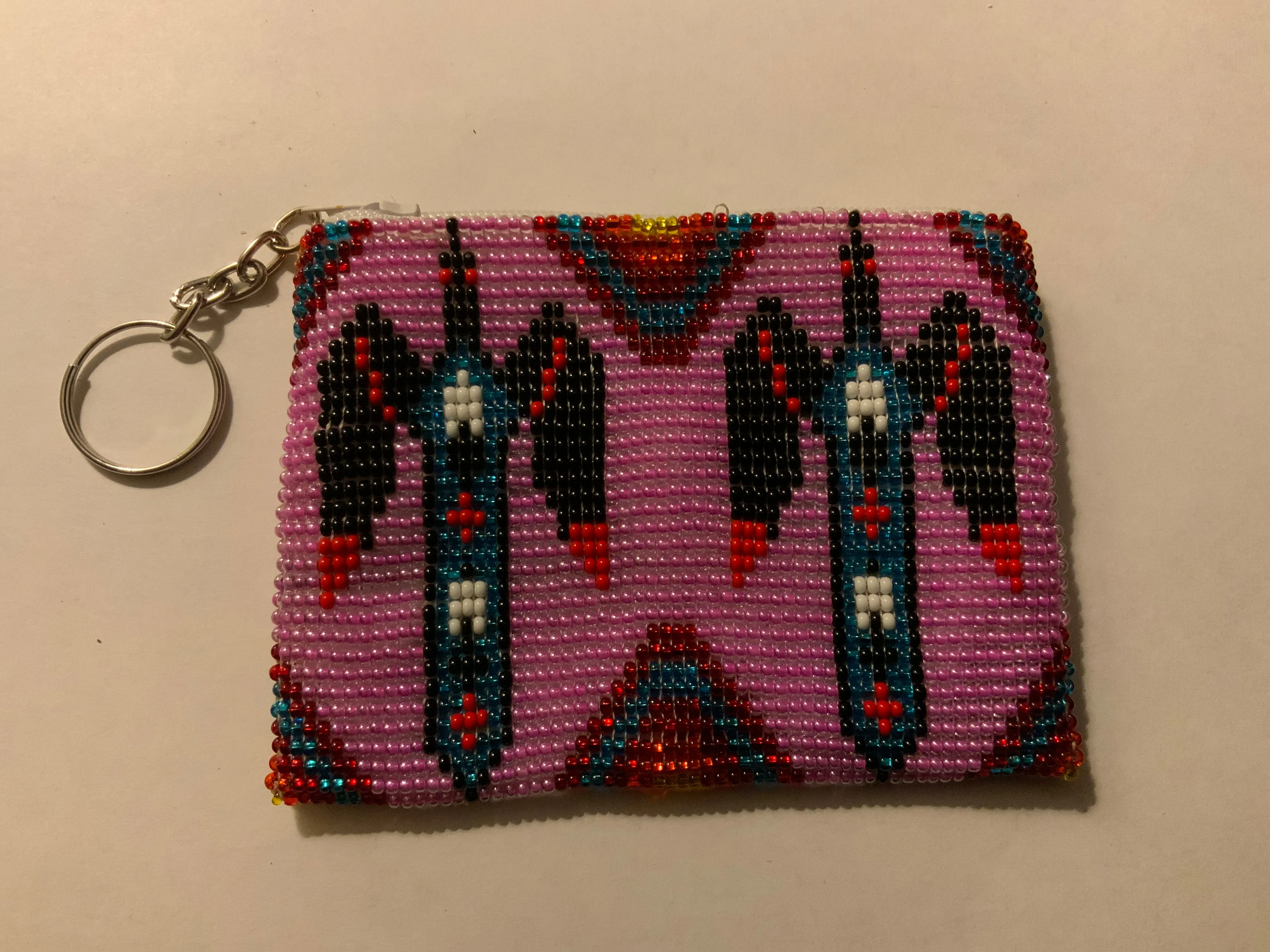 Guatemalan handcrafted glass bead change purse in intricate designs.