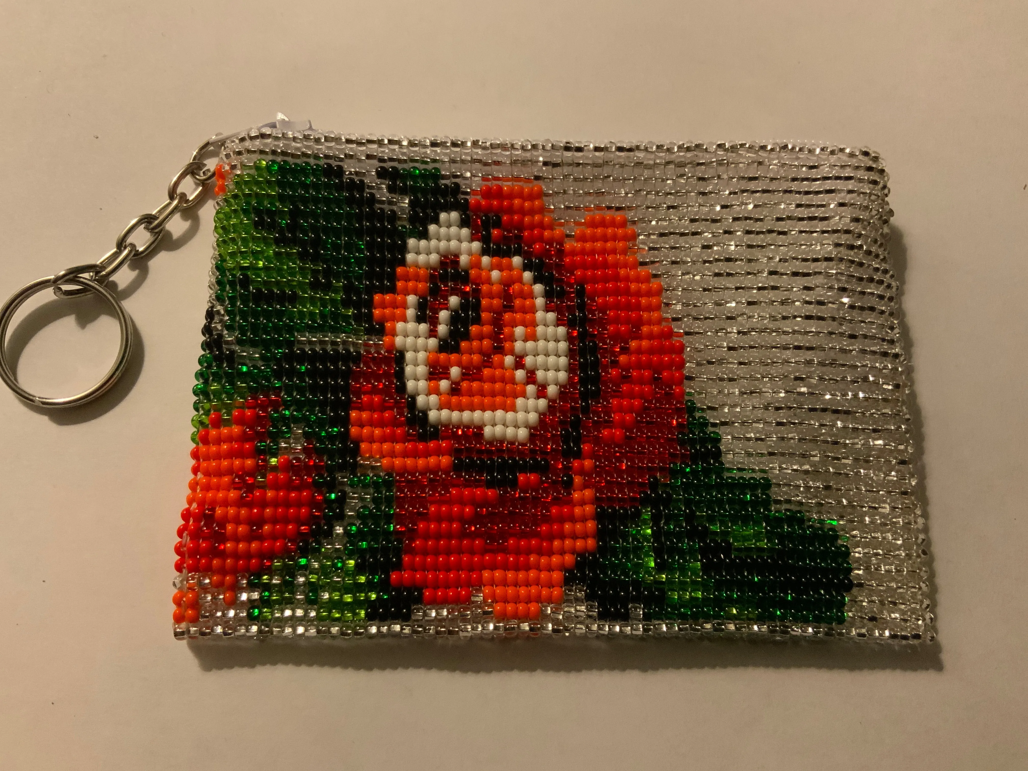 Guatemalan handcrafted glass bead change purse in intricate designs.