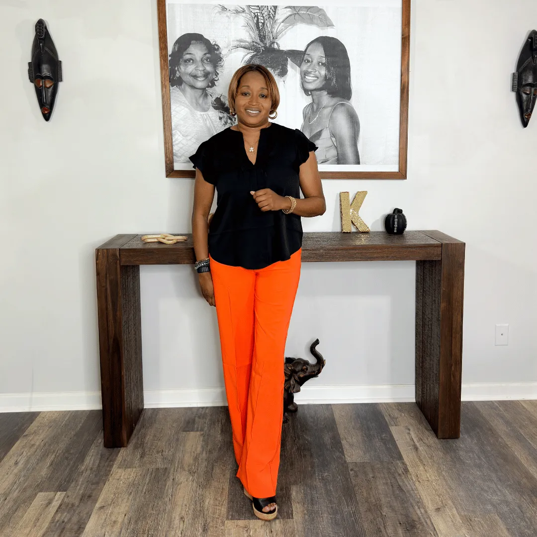 High waisted pants in orange color with an edgy style